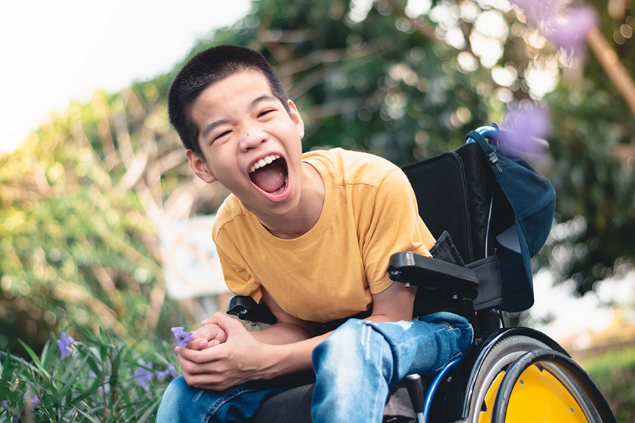 Disabled child on wheelchair is playing, learning and exercise in the outdoor city park like other people,Lifestyle of special child